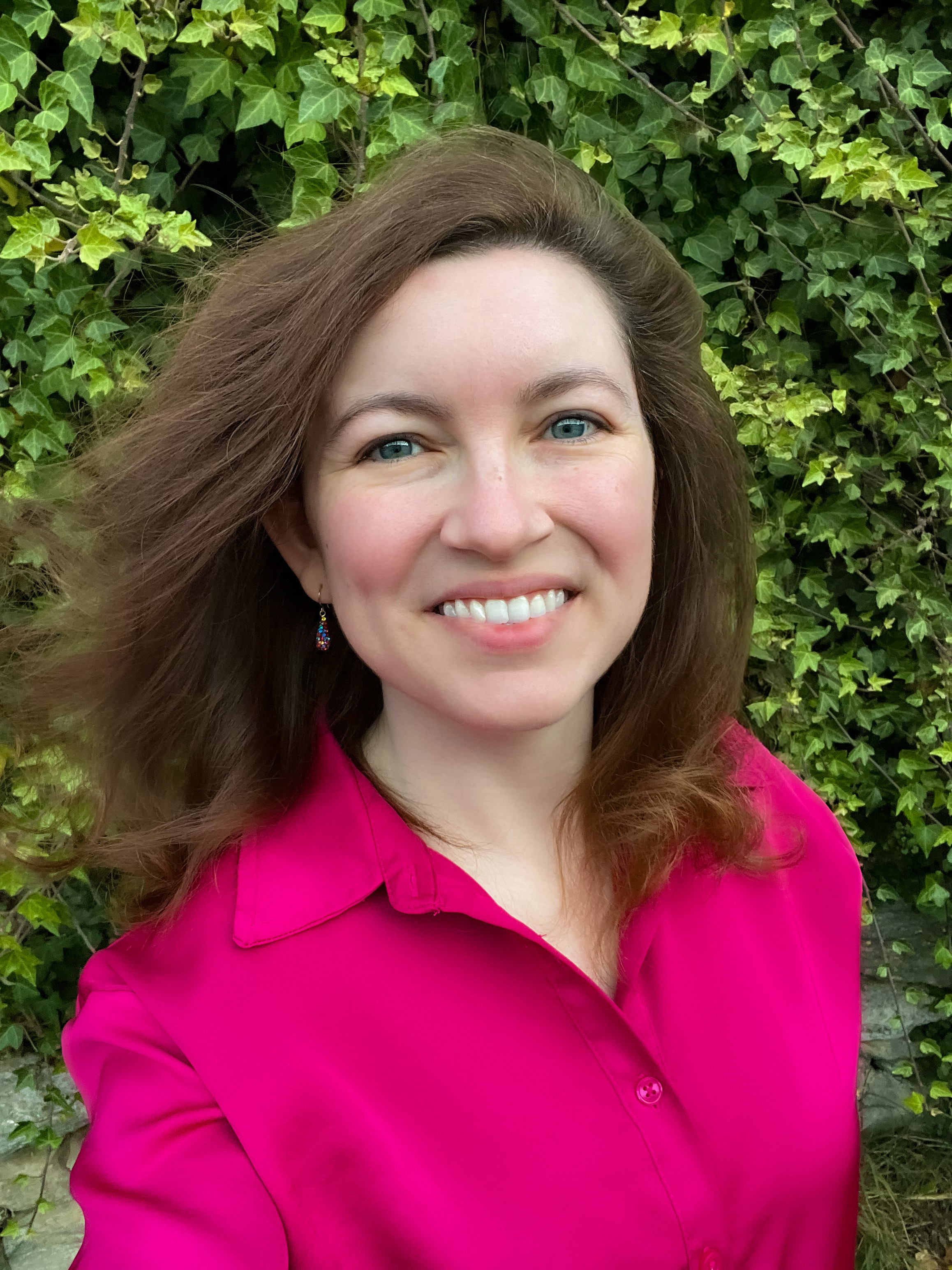 Emily Brooks in a bright top