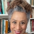Zita Nunes standing in front of a bookshelf