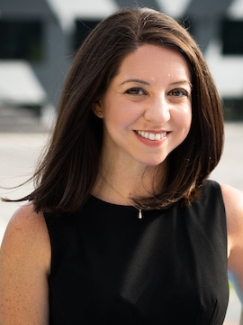 Dr. Amanda Licastro in a black dress standing outdoors