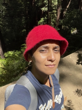 Noopur Raval wearing red hat