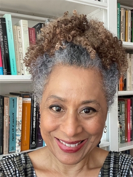 Zita Nunes standing in front of a bookshelf